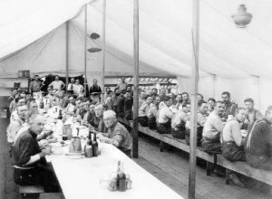 Lumberjacks eat in a mess tent at the McCloud River Lumber Company around 1905.