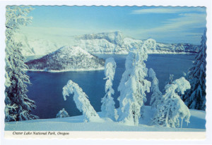 Title (front): Crater Lake National Park, Oregon Back Caption: Crater Lake National Park, Oregon. Wizard Island lifts its sugar-loaf cone from the blue waters. Beyond is the rugged Llao Rock, 2000 feet above the lake in a dazzling winter scene, set off by fantastic figures of snow-encrusted trees parading on the white carpet in the foreground. Card Number(s): B2903 (back) Photographer: Josef Muench Publisher: The Continental card, Mike Roberts, Berkeley, Distributed by Crater Lake Lodge, Inc.